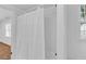 Bathroom tub with a white shower curtain and a window that provides natural light at 1590 Sunnybrook Farm Rd, Atlanta, GA 30350