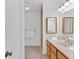 Bathroom with a single sink, white countertops, wood cabinets, and wall mirrors at 1590 Sunnybrook Farm Rd, Atlanta, GA 30350