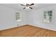 Bright bedroom features beautiful hardwood floors, ceiling fan, and large windows at 1590 Sunnybrook Farm Rd, Atlanta, GA 30350