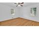 Bedroom with hardwood floors, windows providing natural light, and a ceiling fan at 1590 Sunnybrook Farm Rd, Atlanta, GA 30350
