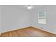Spacious bedroom with hardwood floors and a bright, sunny window at 1590 Sunnybrook Farm Rd, Atlanta, GA 30350