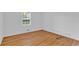 Bright bedroom features beautiful hardwood floors, two HVAC vents, and large window at 1590 Sunnybrook Farm Rd, Atlanta, GA 30350