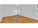 Bright bedroom with hardwood floors, white walls, and natural light from a window at 1590 Sunnybrook Farm Rd, Atlanta, GA 30350