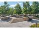 Steps lead to a patio area with seating and shade trees for relaxation in the heart of City Springs at 1590 Sunnybrook Farm Rd, Atlanta, GA 30350