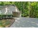 Long driveway leading to a house with garage surrounded by lush greenery at 1590 Sunnybrook Farm Rd, Atlanta, GA 30350