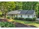 Beautiful single-story home with green lawn, tasteful landscaping, and an attached carport at 1590 Sunnybrook Farm Rd, Atlanta, GA 30350