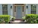 Charming front entrance featuring a light-blue door, decorative lighting, and beautifully manicured landscaping at 1590 Sunnybrook Farm Rd, Atlanta, GA 30350