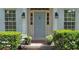 Close-up of a charming front door framed by lush greenery, stylish lanterns, and well-maintained siding at 1590 Sunnybrook Farm Rd, Atlanta, GA 30350