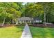 Charming single-story home featuring manicured landscaping, a well-maintained lawn, and a welcoming entrance at 1590 Sunnybrook Farm Rd, Atlanta, GA 30350