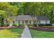 Charming single-story home featuring manicured landscaping, a well-maintained lawn, and a welcoming entrance at 1590 Sunnybrook Farm Rd, Atlanta, GA 30350