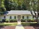 Charming single-story home with manicured front yard and walkway leading to a blue front door at 1590 Sunnybrook Farm Rd, Atlanta, GA 30350