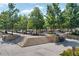 Well-maintained outdoor gathering space with ample seating beneath trees, inviting community connection and relaxation at 1590 Sunnybrook Farm Rd, Atlanta, GA 30350
