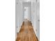 Hallway with hardwood floors and white walls, leading to various rooms at 1590 Sunnybrook Farm Rd, Atlanta, GA 30350