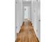 Bright hallway features beautiful hardwood floors, connecting various rooms within the home at 1590 Sunnybrook Farm Rd, Atlanta, GA 30350