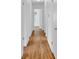 Long hallway with hardwood floors connects the bedrooms to the main living area at 1590 Sunnybrook Farm Rd, Atlanta, GA 30350