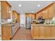 Spacious kitchen features stainless steel appliances and natural wood cabinets at 1590 Sunnybrook Farm Rd, Atlanta, GA 30350