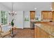 Well-lit kitchen area includes granite countertops, wood cabinets, and a cozy breakfast nook at 1590 Sunnybrook Farm Rd, Atlanta, GA 30350