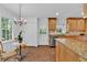 Kitchen with island, granite countertops, stainless dishwasher and chandelier in breakfast area at 1590 Sunnybrook Farm Rd, Atlanta, GA 30350