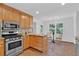 Well-lit kitchen features granite countertops, stainless steel appliances, and a breakfast table set by the window at 1590 Sunnybrook Farm Rd, Atlanta, GA 30350