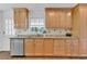 Kitchen with granite countertops, wood cabinets, and stainless steel dishwasher at 1590 Sunnybrook Farm Rd, Atlanta, GA 30350