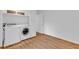 Laundry area featuring modern washer and dryer, shelving, and hardwood floors at 1590 Sunnybrook Farm Rd, Atlanta, GA 30350