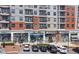 Exterior view of a modern building with various retail stores on the ground floor and residential apartments above at 1590 Sunnybrook Farm Rd, Atlanta, GA 30350