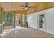 Relaxing screened porch boasts wood accents and outdoor seating, creating an inviting space to enjoy nature at 1590 Sunnybrook Farm Rd, Atlanta, GA 30350