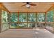 Spacious screened porch with wood ceiling and flooring, offering serene views of the surrounding greenery at 1590 Sunnybrook Farm Rd, Atlanta, GA 30350