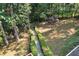 Aerial view of stone walkway bordered by manicured hedges, creating a charming garden path through the yard at 1590 Sunnybrook Farm Rd, Atlanta, GA 30350