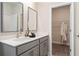Bathroom displays double sinks, framed mirrors, and a closet to add storage space at 3268 Shirecrest Ln, Dacula, GA 30019
