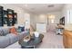 Well-lit living room showcasing a gray couch and storage options at 3268 Shirecrest Ln, Dacula, GA 30019