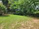 Manicured back yard with green grass and patio at 535 Village Cir, Stockbridge, GA 30281