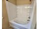 Clean, white bathtub and shower combination with tile surround at 535 Village Cir, Stockbridge, GA 30281