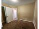 Carpeted bedroom with closet and view to the adjacent rooms at 535 Village Cir, Stockbridge, GA 30281