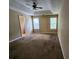 Spacious bedroom with neutral walls, carpet, and a tray ceiling at 535 Village Cir, Stockbridge, GA 30281