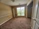 Bedroom with a window, carpeted floor, and a closet at 535 Village Cir, Stockbridge, GA 30281