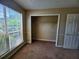 Bedroom featuring a large window and a closet with wire shelving at 535 Village Cir, Stockbridge, GA 30281
