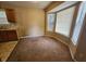 Eat-in kitchen featuring a large bay window, dark cabinets and room for a table at 535 Village Cir, Stockbridge, GA 30281