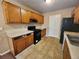 Galley-style kitchen featuring stainless steel appliances, modern cabinetry, and a black refrigerator at 535 Village Cir, Stockbridge, GA 30281