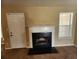 Living room featuring a white fireplace with black accents, carpet and a window at 535 Village Cir, Stockbridge, GA 30281