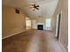 Spacious living room featuring a fireplace, carpet and a ceiling fan at 535 Village Cir, Stockbridge, GA 30281