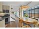 Bright dining area with large windows, stylish lighting, and an adjacent kitchen area at 770 Barnett Street Ne, Atlanta, GA 30306
