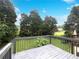 Back deck overlooking the yard surrounded by lush trees at 7972 Woodlake Dr, Riverdale, GA 30274