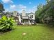 Expansive backyard with a deck, staircase, and mature trees, ideal for outdoor living at 7972 Woodlake Dr, Riverdale, GA 30274