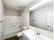 Clean bathroom featuring large mirror, shower-tub combo, and modern vanity at 7972 Woodlake Dr, Riverdale, GA 30274