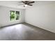 Neutral bedroom with ceiling fan and large window, providing natural light and a scenic view at 7972 Woodlake Dr, Riverdale, GA 30274