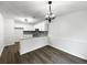 Dining area and kitchen with white cabinetry, stainless appliances, and granite countertops at 7972 Woodlake Dr, Riverdale, GA 30274