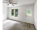 Spacious living room with new carpet, exterior door, and large picture window at 7972 Woodlake Dr, Riverdale, GA 30274