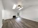 Spacious living room featuring high ceilings, skylights, and a cozy fireplace at 7972 Woodlake Dr, Riverdale, GA 30274