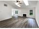 Spacious living room with high ceilings, hardwood floors, and a fireplace at 7972 Woodlake Dr, Riverdale, GA 30274